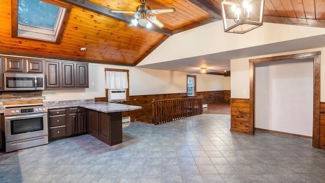 kitchen with appliances with stainless steel finishes, dark brown cabinetry, wooden ceiling, and vaulted ceiling with skylight