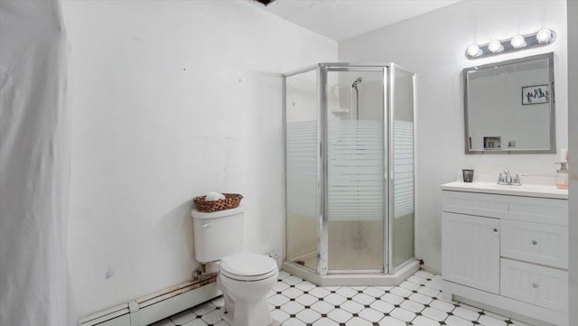 bathroom with vanity, toilet, a shower with door, and a baseboard radiator