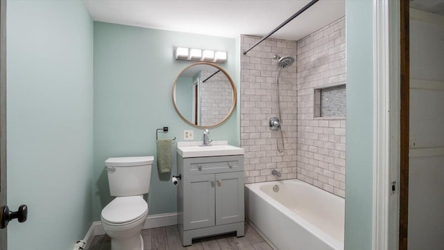 full bathroom with tiled shower / bath, vanity, and toilet