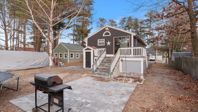 exterior space featuring a storage shed and a trampoline