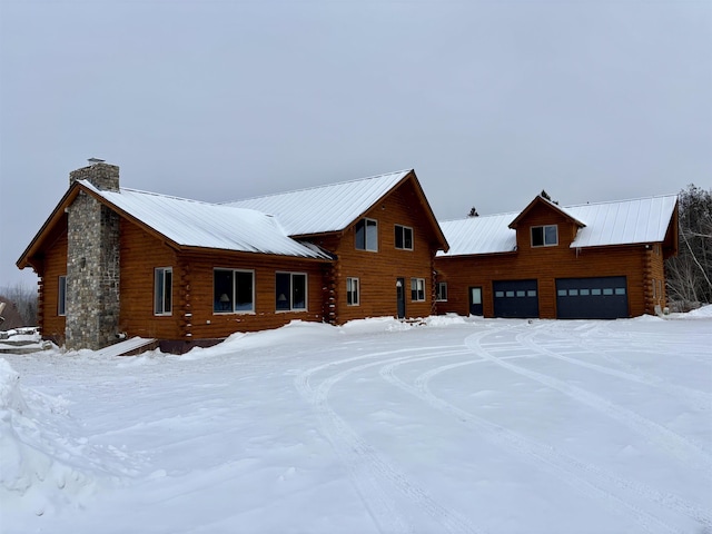 view of snow covered back of property