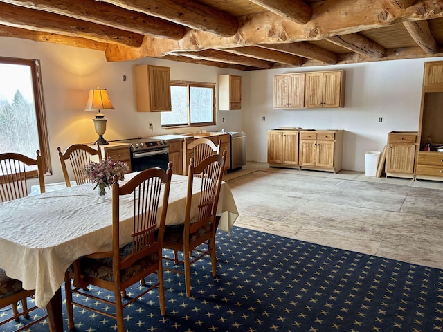 dining space with beam ceiling