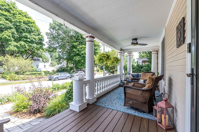 wooden deck featuring ceiling fan and a porch