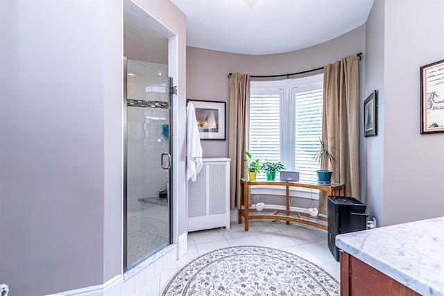 bathroom featuring tile patterned floors, vanity, and walk in shower