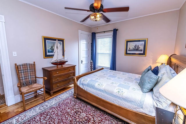 bedroom with wood-type flooring, ceiling fan, and ornamental molding