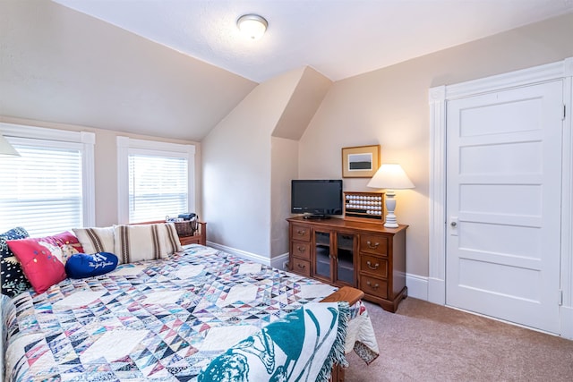 bedroom with carpet and lofted ceiling