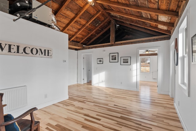 unfurnished living room with vaulted ceiling with beams, wooden ceiling, and light wood-type flooring