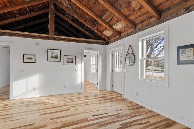 foyer featuring vaulted ceiling with beams, light hardwood / wood-style flooring, and wood ceiling