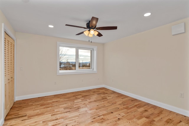 unfurnished bedroom with ceiling fan and light wood-type flooring