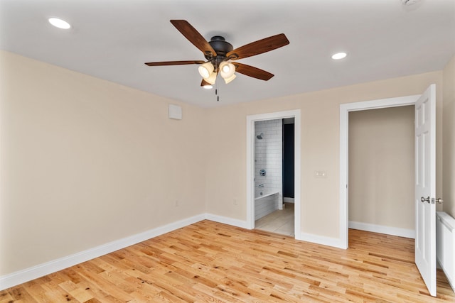 unfurnished bedroom with light hardwood / wood-style floors, ensuite bath, and ceiling fan