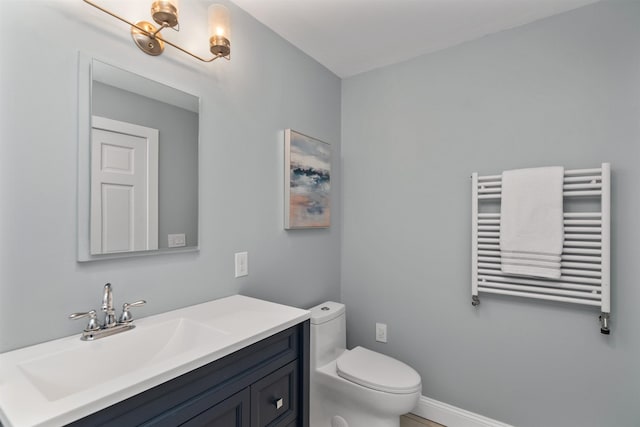 bathroom featuring vanity, toilet, and radiator heating unit