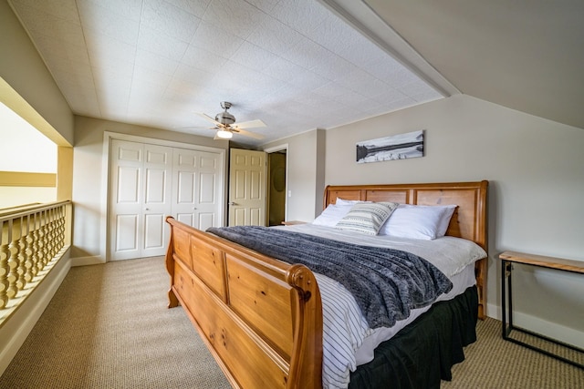 bedroom with a closet, light colored carpet, ceiling fan, and lofted ceiling