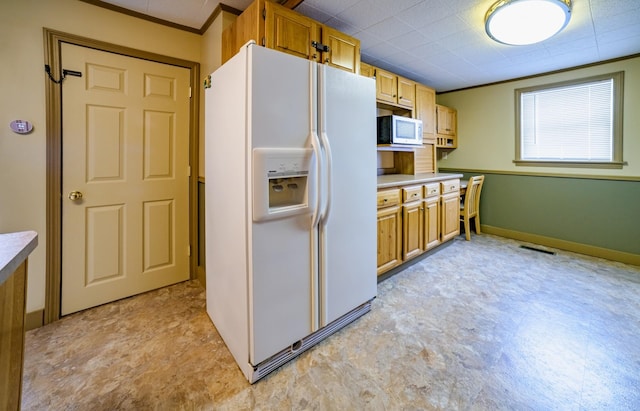 kitchen with white appliances and ornamental molding