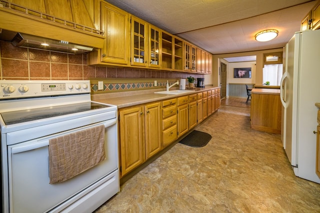 kitchen featuring tasteful backsplash, custom range hood, white appliances, and sink