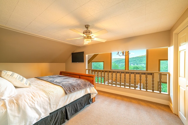 carpeted bedroom with ceiling fan and lofted ceiling