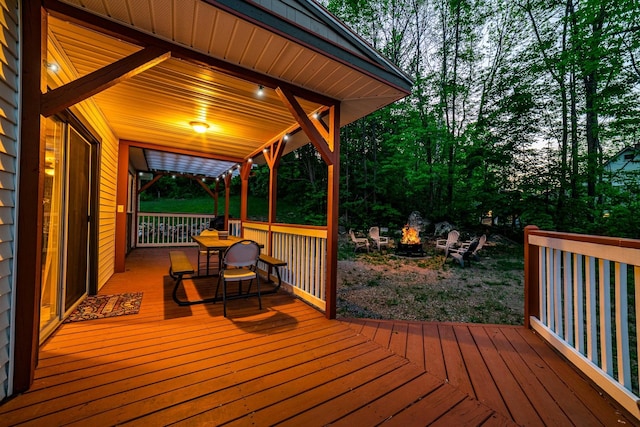 wooden terrace with a fire pit