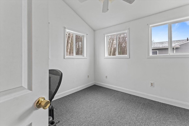 unfurnished office with carpet flooring, ceiling fan, and vaulted ceiling