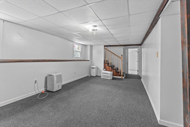 basement with carpet floors and a paneled ceiling