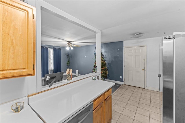 kitchen with appliances with stainless steel finishes, ceiling fan, and light tile patterned flooring