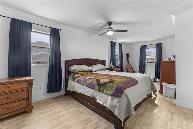 bedroom with a textured ceiling, ceiling fan, crown molding, and light hardwood / wood-style flooring