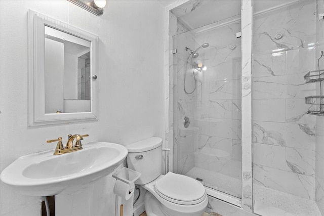 bathroom with toilet, an enclosed shower, and sink