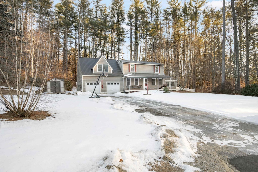 view of property featuring covered porch and a storage unit