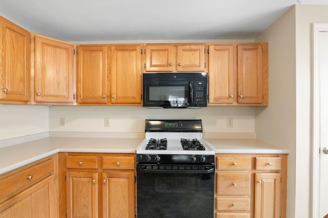 kitchen with light brown cabinetry and black appliances