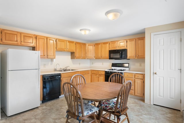 kitchen with sink, black appliances, and light brown cabinets