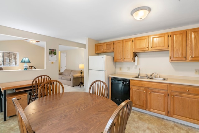 kitchen with sink, white fridge, and black dishwasher