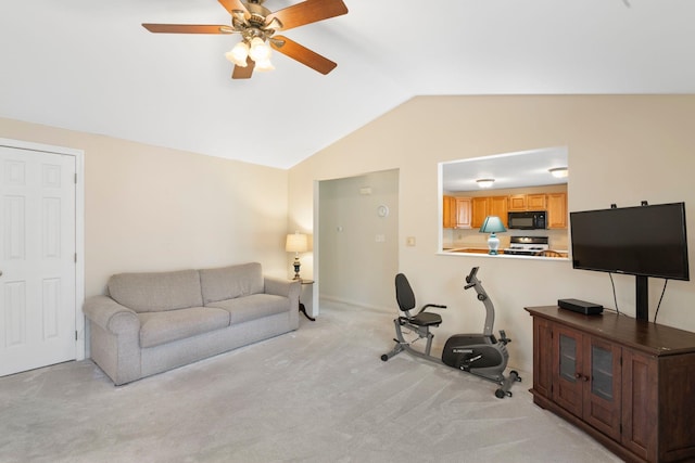 carpeted living room featuring vaulted ceiling and ceiling fan