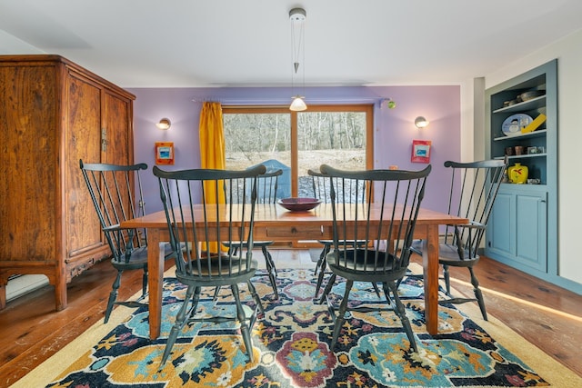 dining room featuring hardwood / wood-style floors and built in features