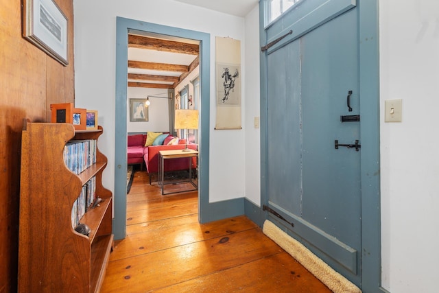 entryway with beamed ceiling and hardwood / wood-style flooring