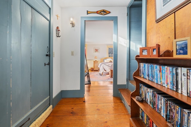 corridor featuring wooden walls and hardwood / wood-style floors