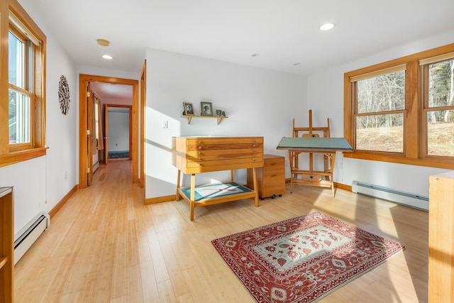 miscellaneous room featuring light hardwood / wood-style flooring and a baseboard heating unit