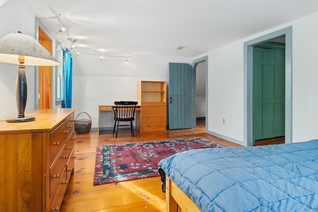 bedroom featuring hardwood / wood-style floors and a closet