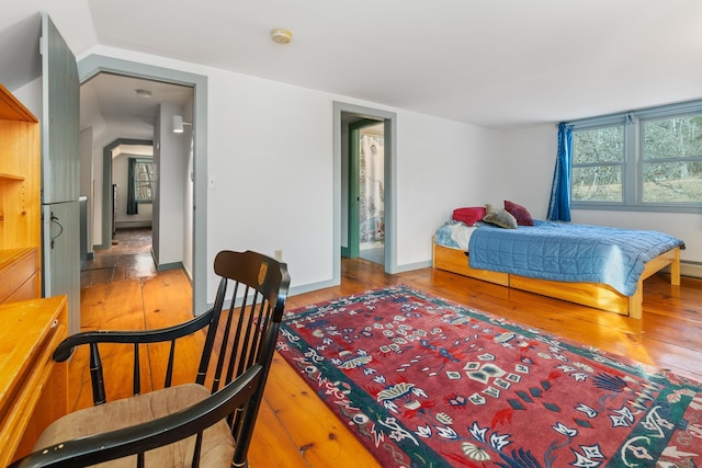 bedroom featuring hardwood / wood-style flooring and vaulted ceiling