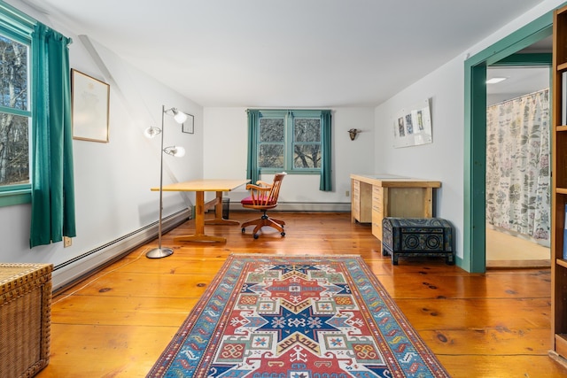 living area with a baseboard radiator and light hardwood / wood-style floors