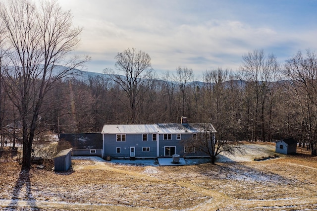 view of front of home featuring a storage unit