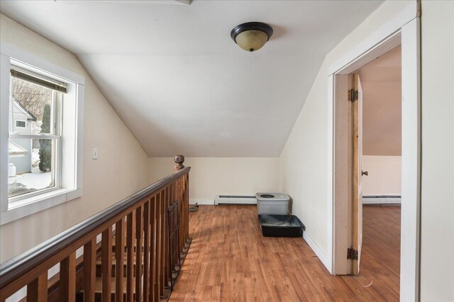 49 Eastern Ave, Richford, VT 05476 - hall with wood-type flooring, vaulted ceiling, and a baseboard heating unit