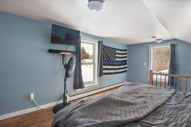 49 Eastern Ave, Richford, VT 05476 - bedroom with hardwood / wood-style floors, lofted ceiling, and a baseboard heating unit