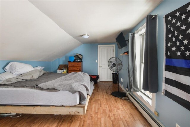 49 Eastern Ave, Richford, VT 05476 - bedroom featuring light hardwood / wood-style flooring, lofted ceiling, and a baseboard heating unit