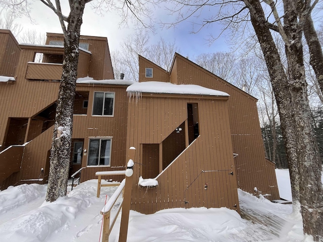 view of snow covered rear of property