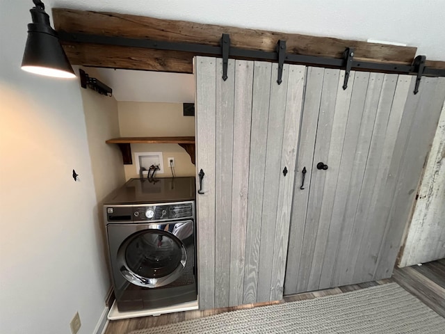 laundry room featuring hardwood / wood-style floors and washer / clothes dryer