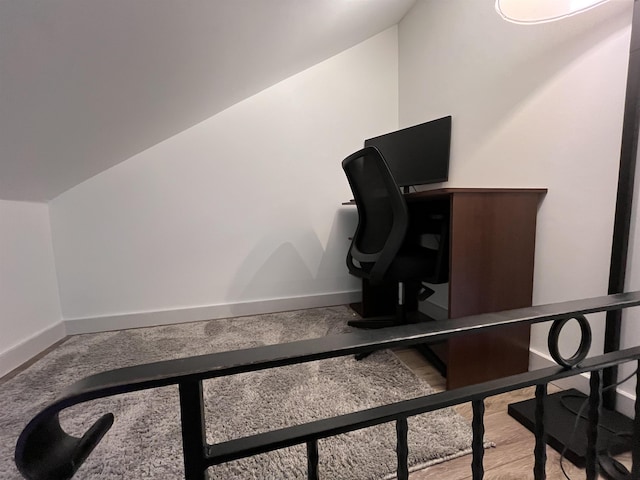 home office with light hardwood / wood-style floors and lofted ceiling