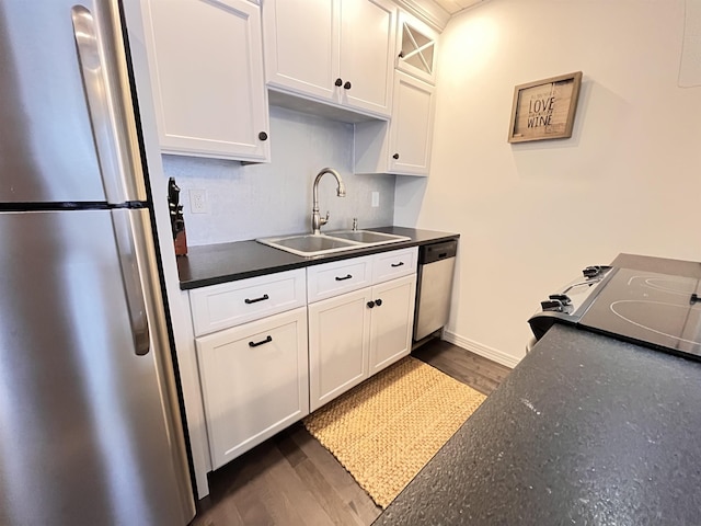 kitchen with sink, white cabinets, dark hardwood / wood-style floors, and appliances with stainless steel finishes