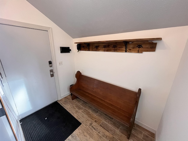 entrance foyer with a textured ceiling and vaulted ceiling