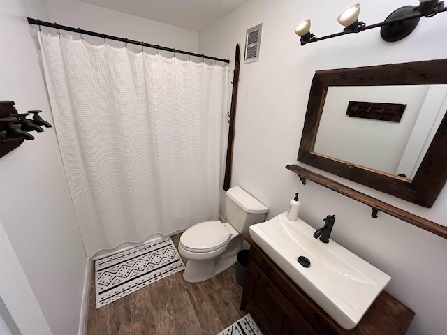 bathroom featuring hardwood / wood-style flooring, vanity, toilet, and a shower with curtain