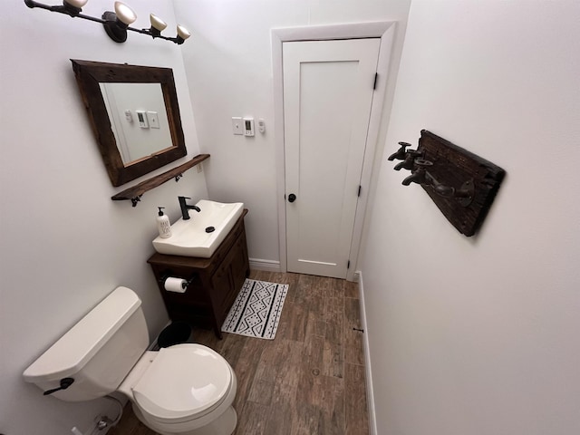 bathroom with vanity, wood-type flooring, and toilet