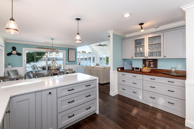 kitchen with wooden counters, gray cabinets, hanging light fixtures, and ceiling fan