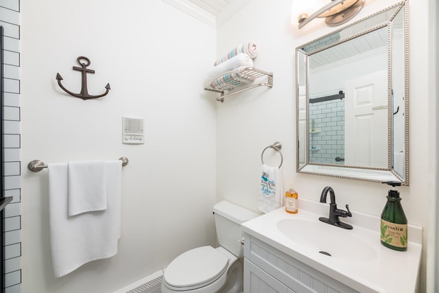 bathroom featuring vanity, ornamental molding, and toilet